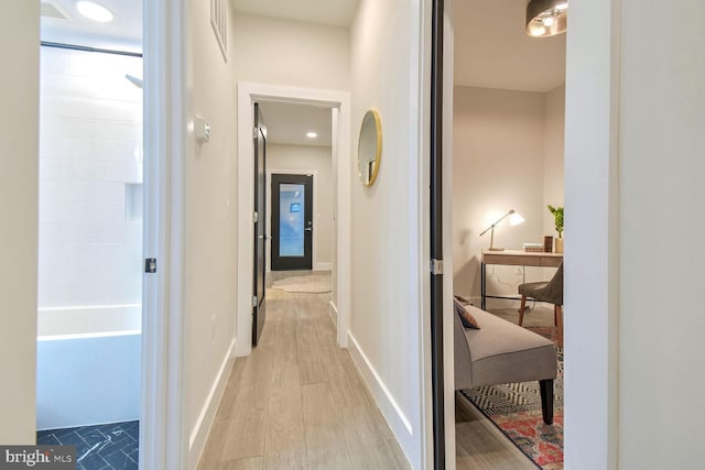 hall with light hardwood / wood-style floors