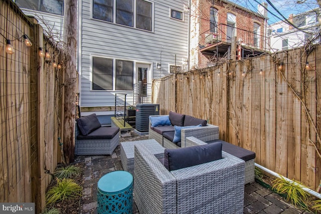 view of patio with an outdoor living space and central air condition unit