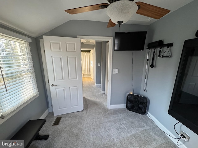 bedroom featuring vaulted ceiling, light colored carpet, and ceiling fan