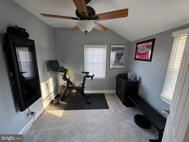 exercise area with vaulted ceiling and carpet flooring