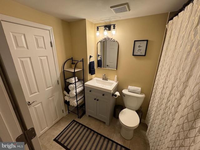 bathroom with tile patterned floors, vanity, and toilet