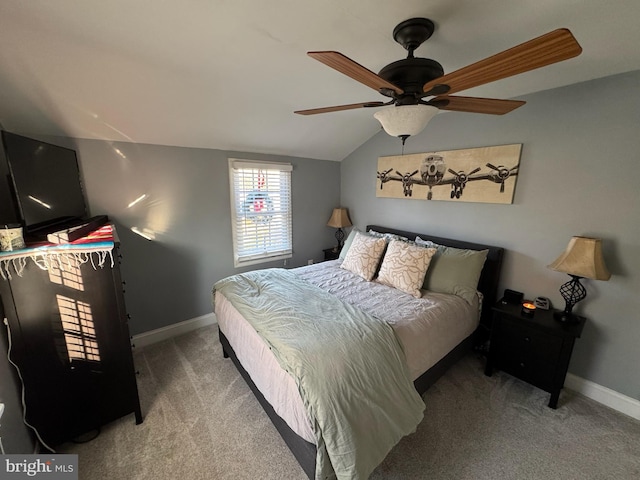 carpeted bedroom with ceiling fan and vaulted ceiling