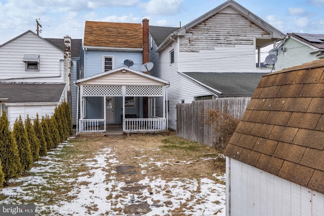 snow covered house with covered porch