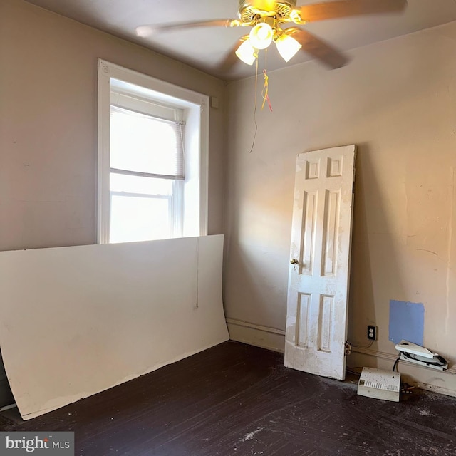 interior space with ceiling fan