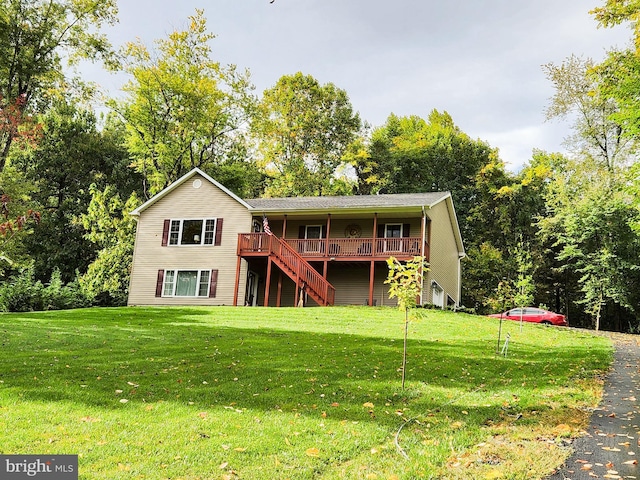 back of property featuring a lawn and a deck