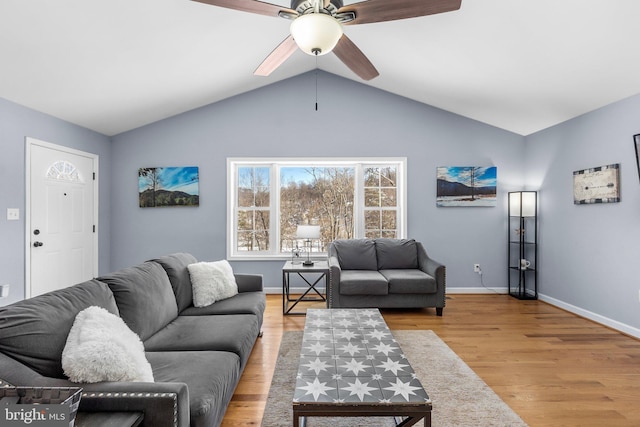 living room featuring ceiling fan, light hardwood / wood-style flooring, and vaulted ceiling