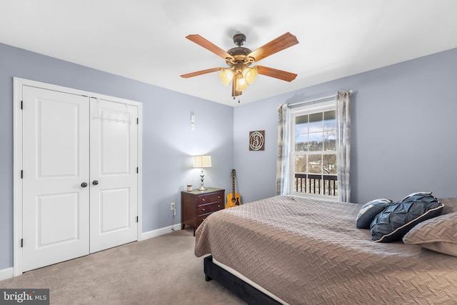 carpeted bedroom featuring ceiling fan and a closet