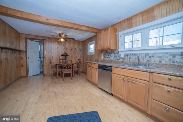 kitchen with stainless steel dishwasher, beam ceiling, sink, and light hardwood / wood-style floors