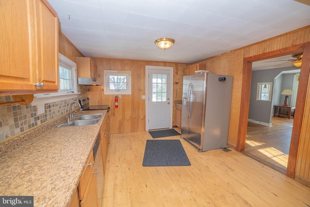 kitchen featuring stainless steel refrigerator with ice dispenser, a wealth of natural light, light wood-type flooring, and sink