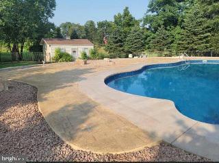 view of swimming pool with an outdoor structure