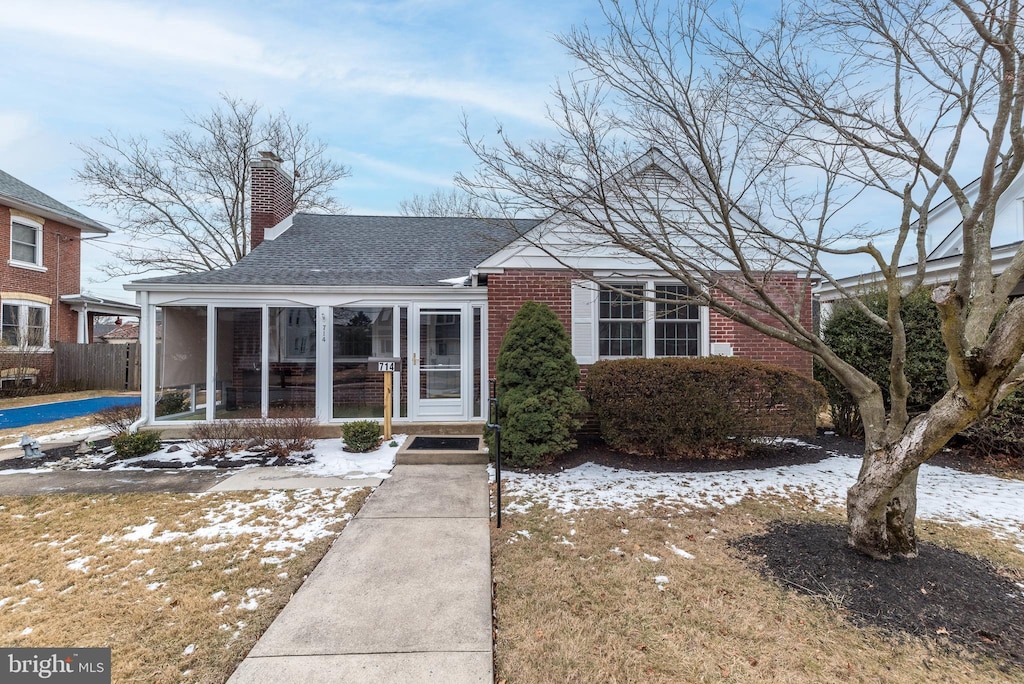 view of front of home with a sunroom