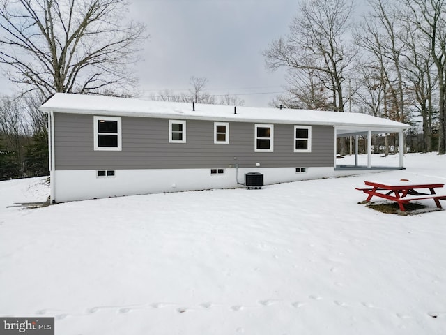 snow covered property featuring cooling unit