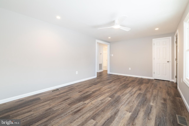 spare room with ceiling fan and dark hardwood / wood-style floors