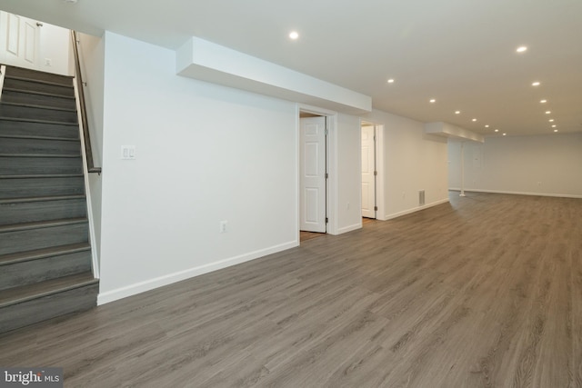 basement with hardwood / wood-style floors