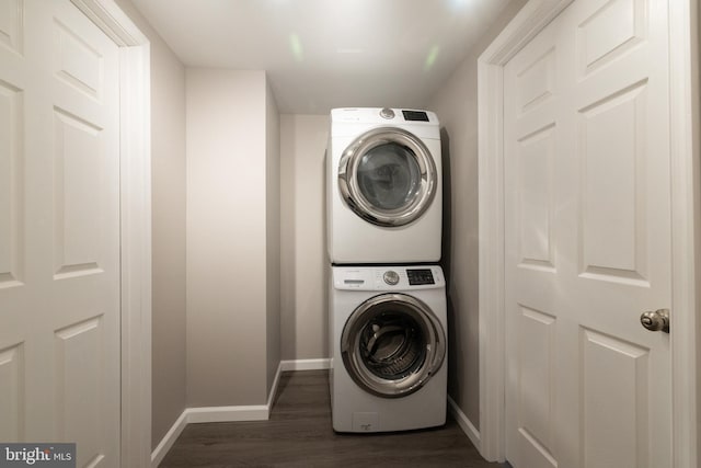 washroom with stacked washer / dryer and dark hardwood / wood-style flooring