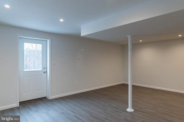 basement with electric panel and dark hardwood / wood-style floors