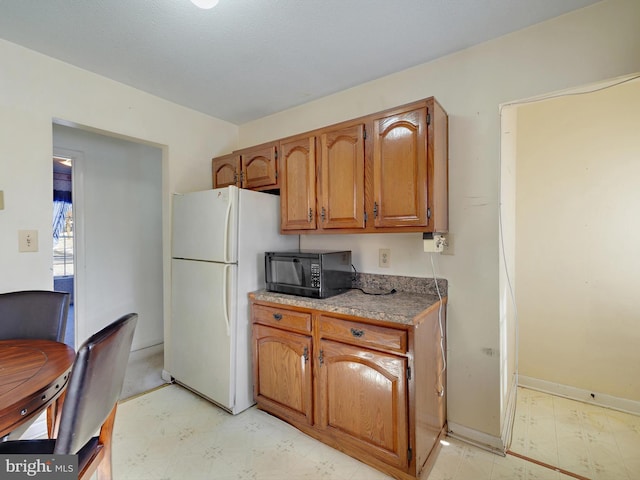 kitchen featuring white fridge