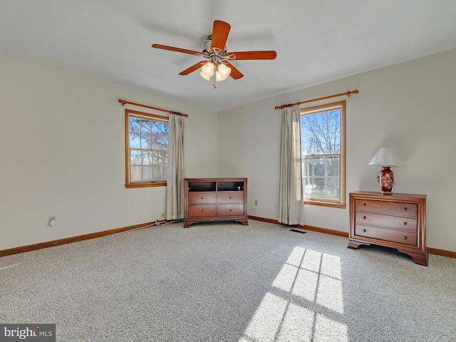 unfurnished room featuring light carpet and ceiling fan