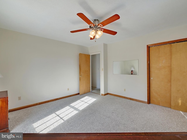 unfurnished bedroom with ceiling fan, a closet, and light colored carpet