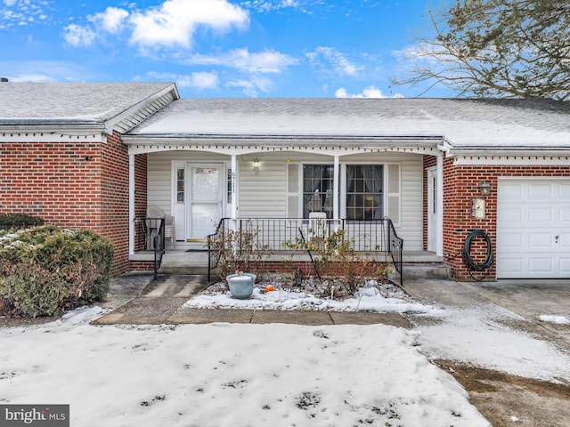 view of front of property featuring covered porch and a garage