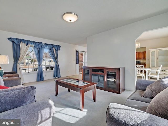 carpeted living room featuring a fireplace