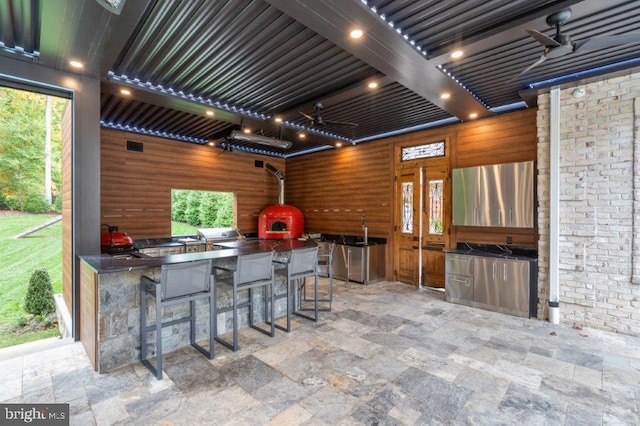 view of patio featuring ceiling fan and an outdoor kitchen