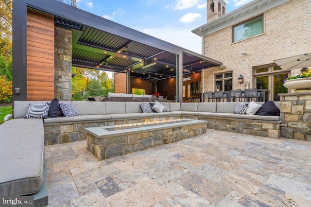 view of patio / terrace with an outdoor living space with a fire pit