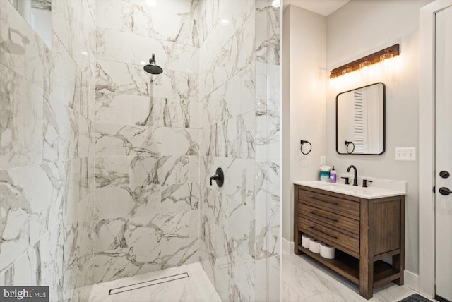 bathroom with vanity and tiled shower