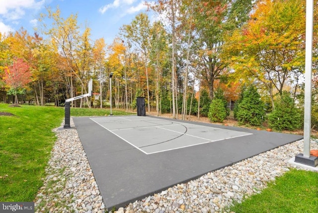 view of basketball court with a lawn