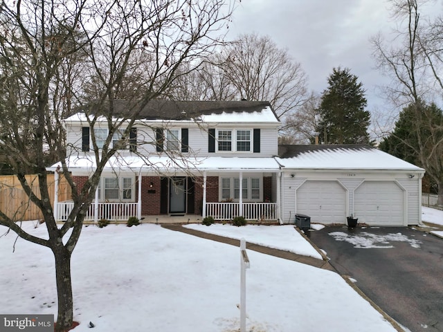 front of property featuring covered porch and a garage