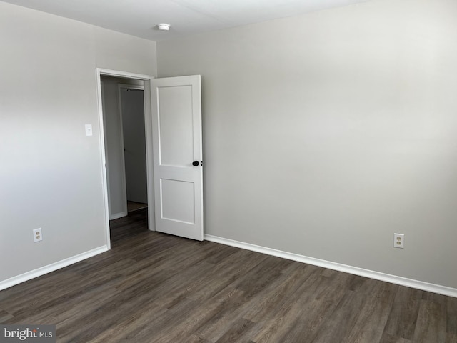 spare room with dark hardwood / wood-style flooring