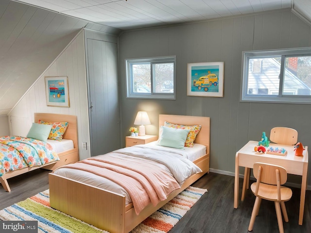 bedroom with lofted ceiling and dark hardwood / wood-style floors