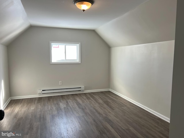 bonus room with a baseboard heating unit, dark hardwood / wood-style flooring, and vaulted ceiling