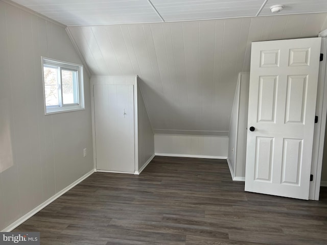 bonus room featuring vaulted ceiling and dark hardwood / wood-style flooring