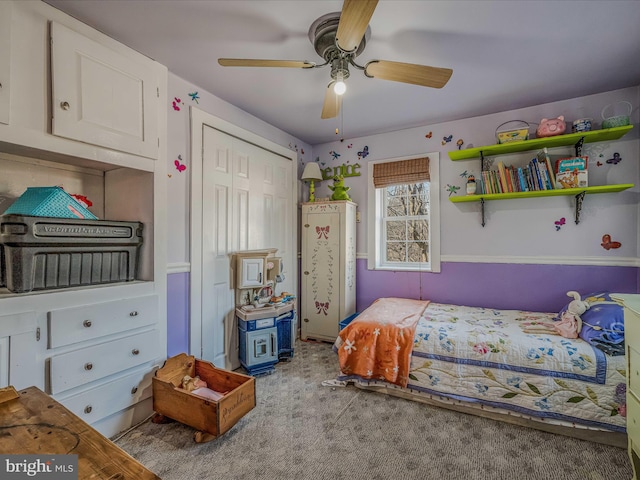 carpeted bedroom featuring ceiling fan and a closet