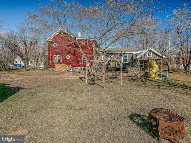 exterior space with a lawn and a playground