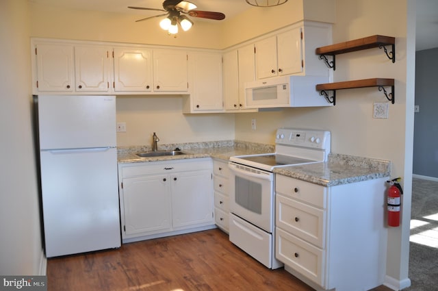 kitchen with ceiling fan, dark hardwood / wood-style floors, sink, white appliances, and white cabinets