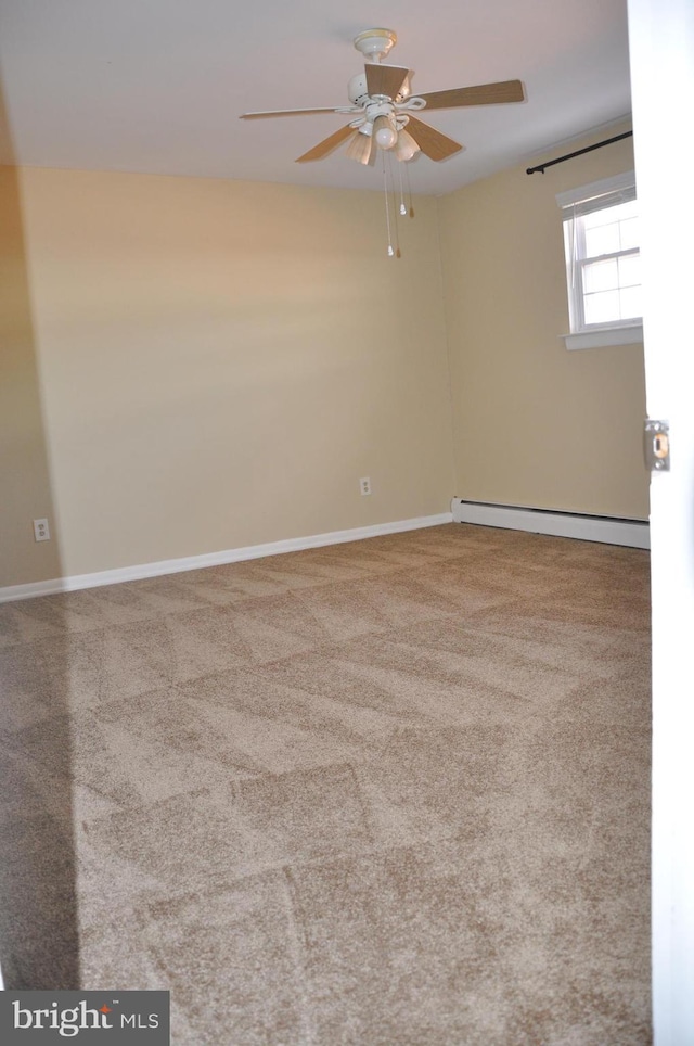 carpeted spare room featuring ceiling fan and baseboard heating