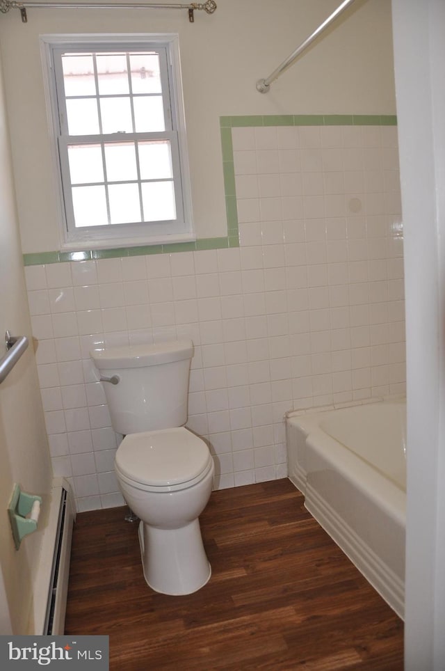 bathroom featuring toilet, baseboard heating, tile walls, and wood-type flooring