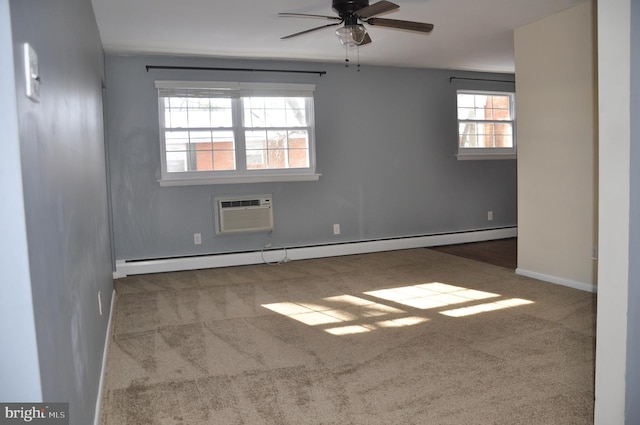 carpeted spare room featuring ceiling fan, a healthy amount of sunlight, baseboard heating, and a wall mounted air conditioner