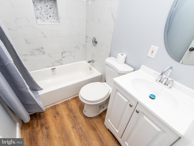 full bathroom featuring hardwood / wood-style flooring, shower / tub combo with curtain, vanity, and toilet