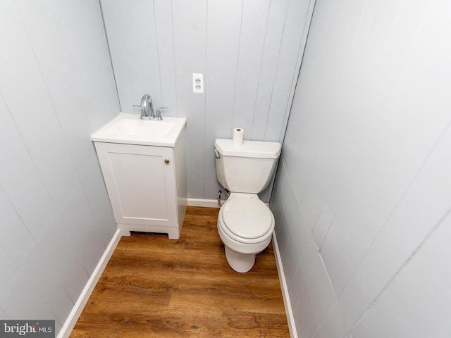 bathroom featuring vanity, hardwood / wood-style floors, and toilet