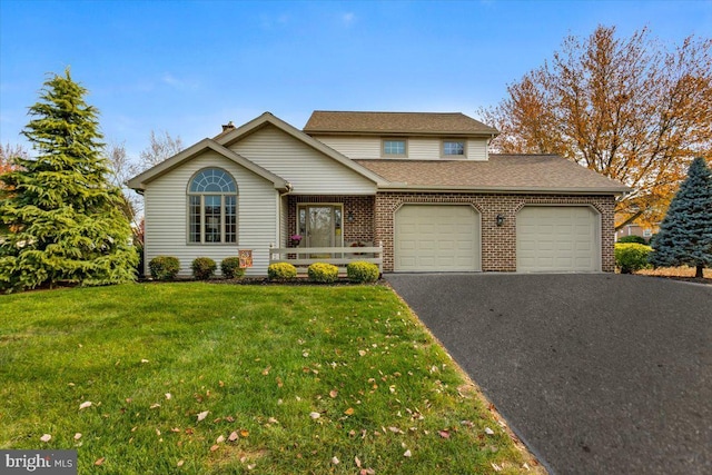 front of property featuring a garage and a front lawn