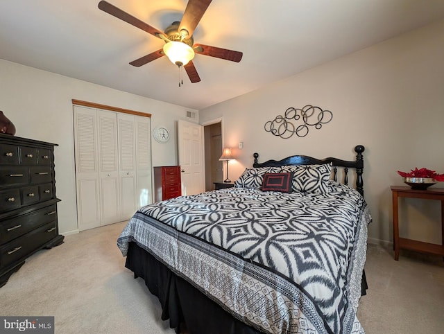 carpeted bedroom with a closet and ceiling fan