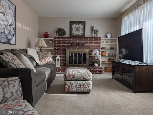 carpeted living room with a brick fireplace