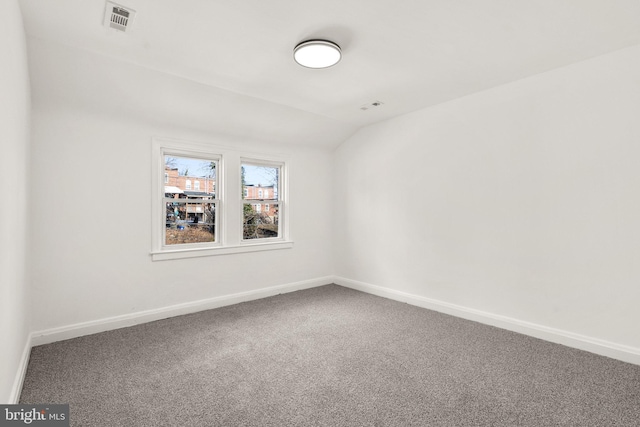 unfurnished room with lofted ceiling and carpet