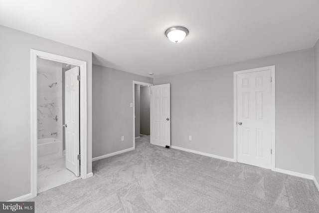 unfurnished bedroom with connected bathroom and light colored carpet