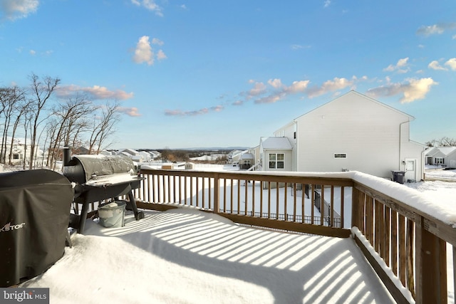 snow covered deck featuring a grill