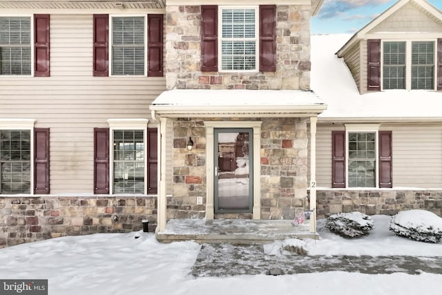 view of snow covered property entrance