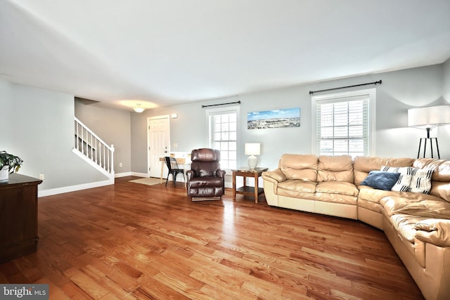 living room featuring wood-type flooring and a wealth of natural light